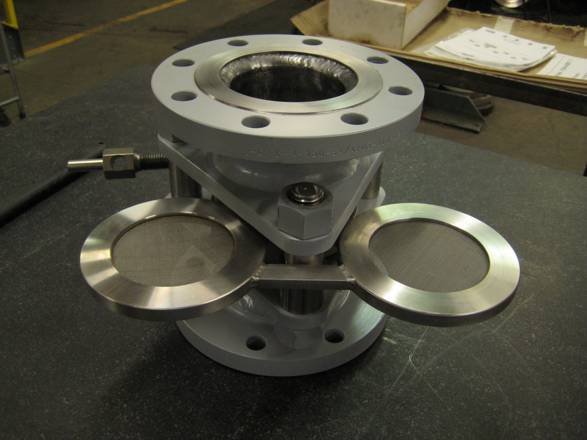 The SchuF Cam-Set line blind can be modified to include orifice plates, strainers (shown) or rupture discs. When the in-line addition needs to be replaced the blind can quickly be swung to replace the worn out plate.